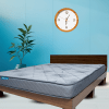 A mattress placed on a bed frame, showcasing a simple and comfortable sleeping arrangement.