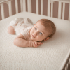 A sleeping baby nestled in a crib, with plush bedding and a soothing environment, representing pure innocence and comfort.