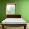 A beautifully designed bed with floral patterns, set against the soft pink walls of a charming bedroom.